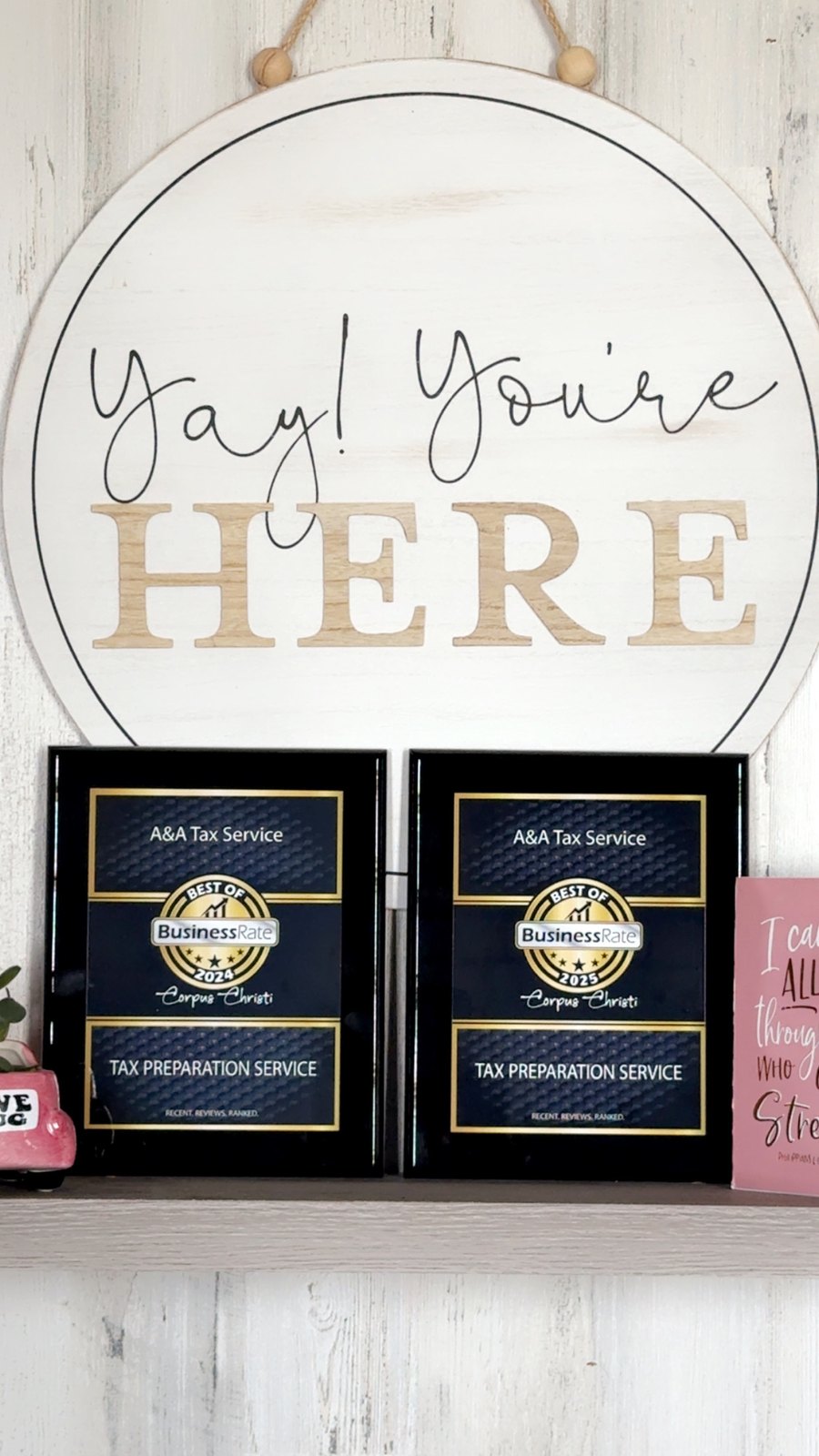 A&A Tax Service Best of BusinessRate award plaques for 2024 and 2025 on the office wall
